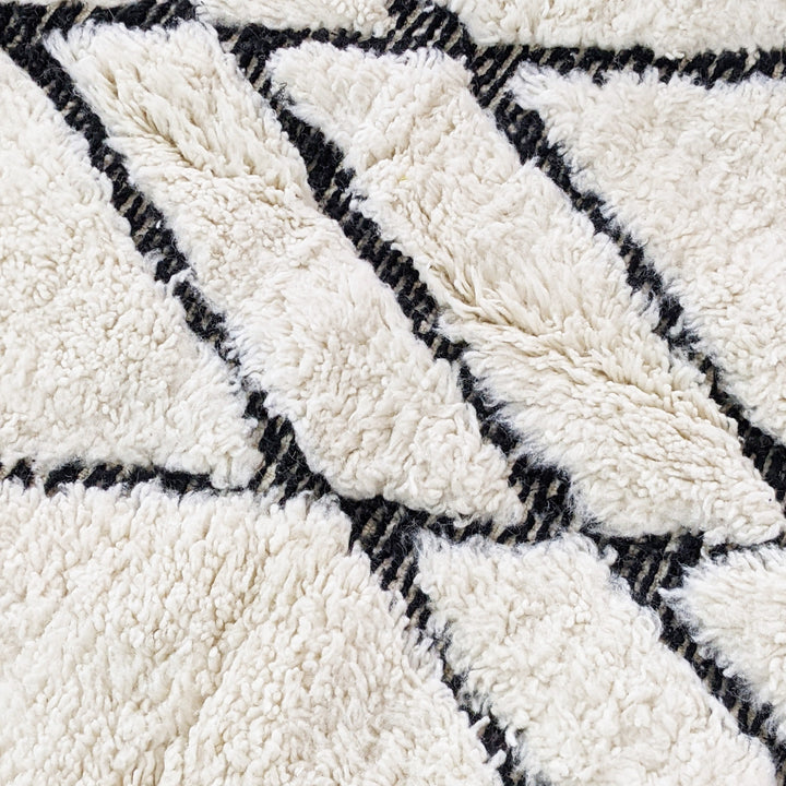 Ivory Black Linear Beni Ourain Style Wool Rug styled in a modern interior
