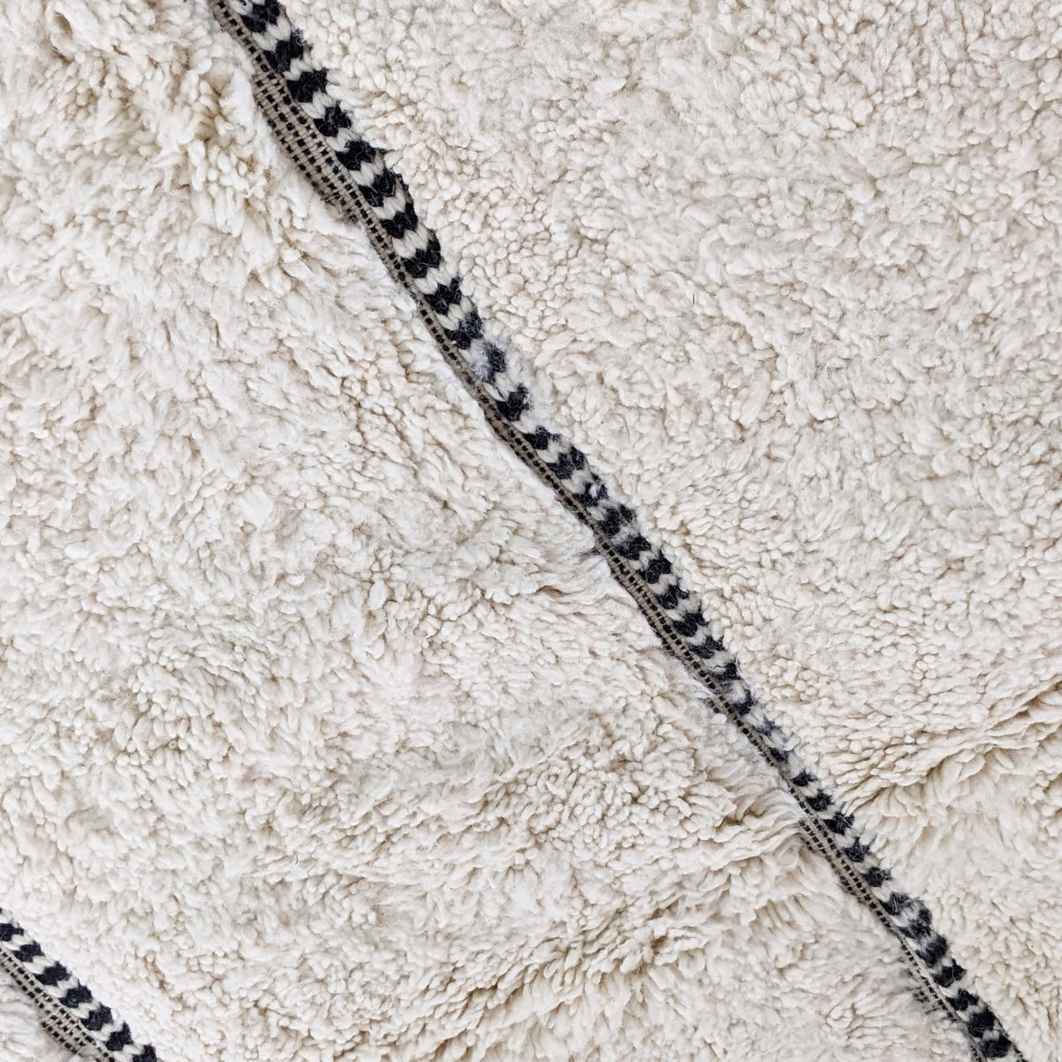 Ivory Striped Beni Ourain Style Moroccan Wool Rug styled in a modern interior
