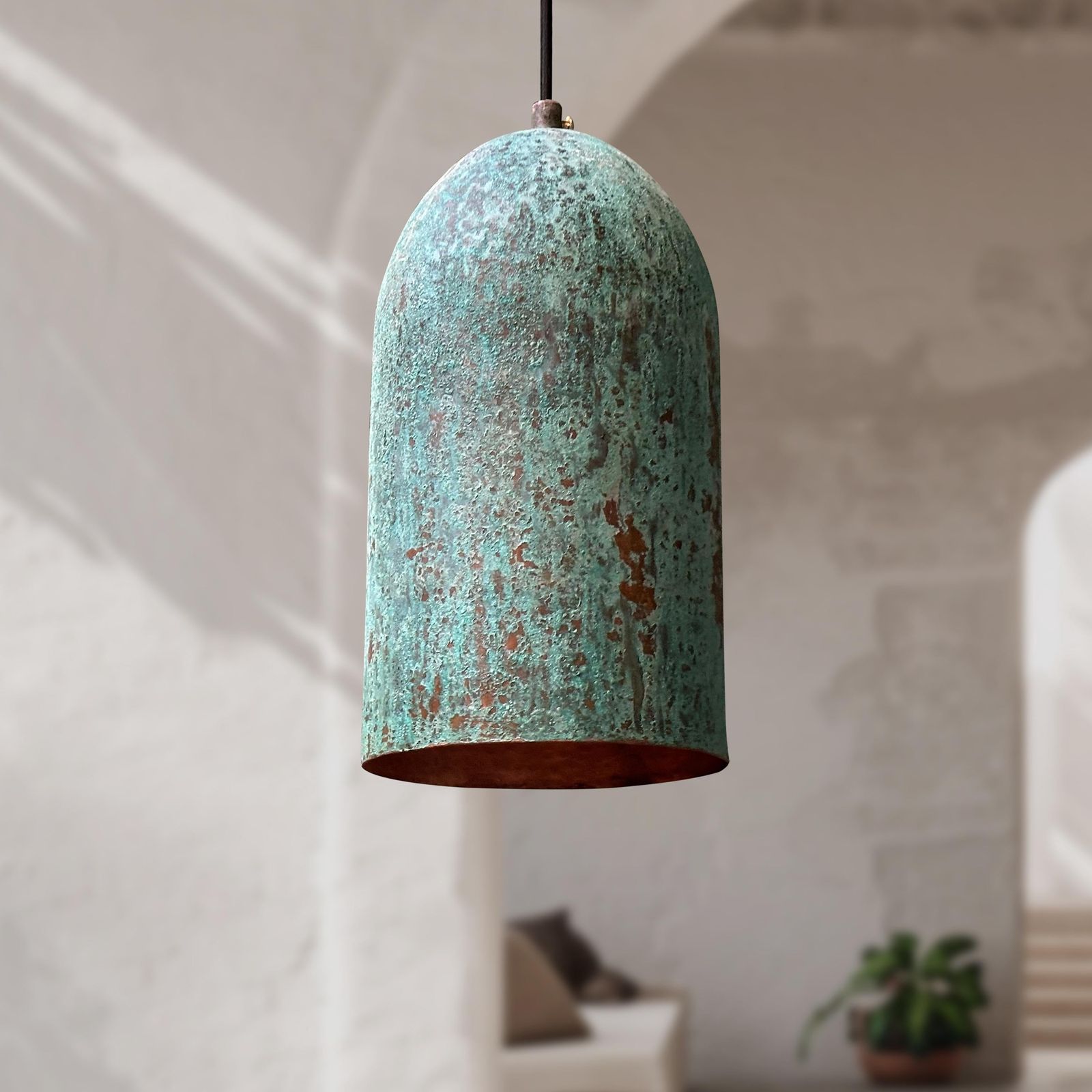 Turquoise pendant light with a textured surface in a room setting