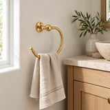 Round solid brass towel ring with linen hand towel in a warm neutral bathroom