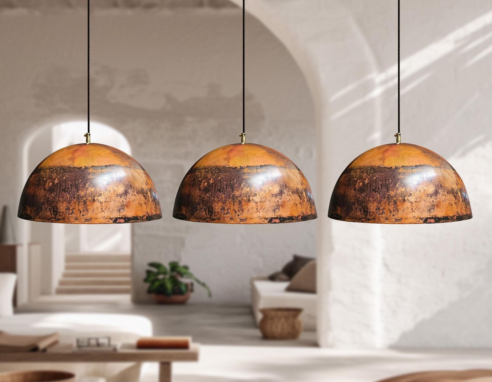 Three pendant lights hanging in a room with a neutral color palette.