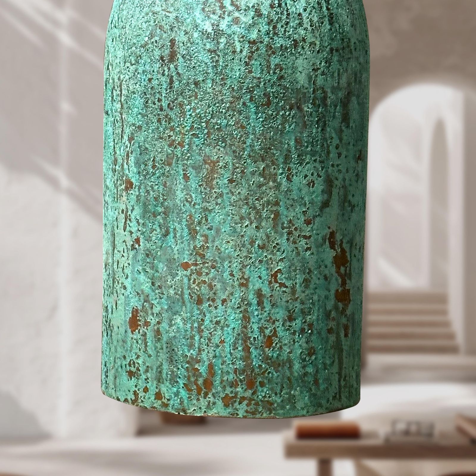 Textured green lampshade on a blurred indoor background