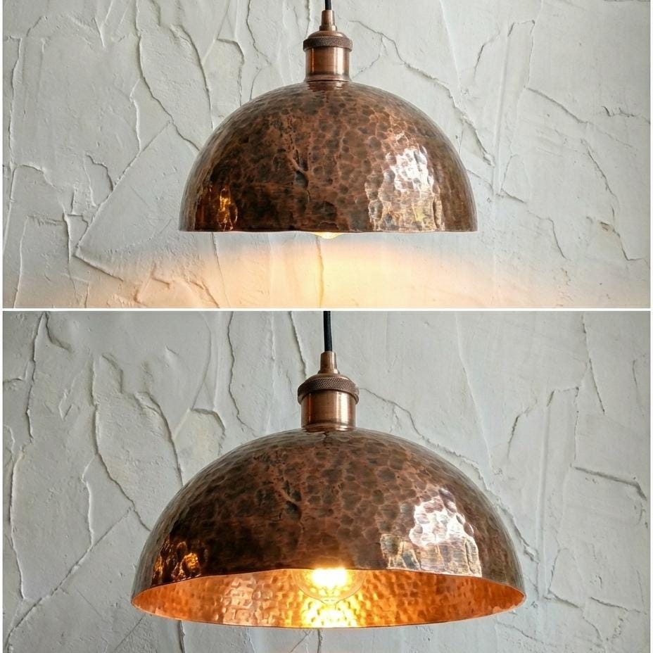 Copper pendant light fixture on a textured white wall
