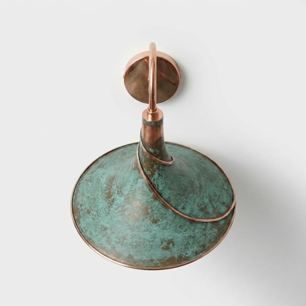A vintage-style wall sconce featuring a wide, dome-shaped shade with a distressed turquoise-green patina and copper-toned metal accents, including the wall mount and top loop.